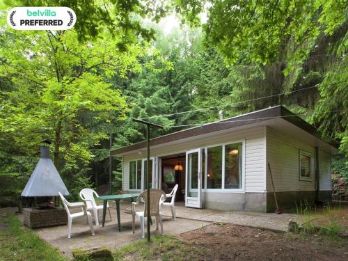 ein kleines Haus mit einem Tisch und Stühlen davor in der Unterkunft Forest Chalet in Lanklaar in Lanklaar