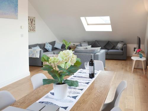 a living room with a table and a couch at Lyndhurst in Perranporth