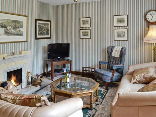 a living room with a couch and a fireplace at Station House - Hw7742 in Glyn-Dyfrdwy