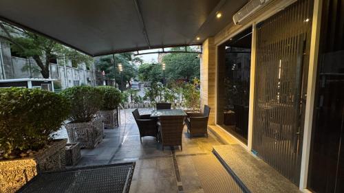 a patio with a table and chairs in a building at Taj Hotel Premium Residency F-7 Islamabad in Islamabad