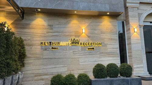 a restaurant sign on the side of a building at Taj Hotel Premium Residency F-7 Islamabad in Islamabad