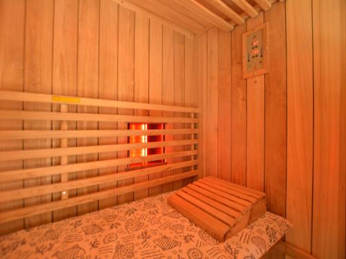 a room with a bed in a wooden room at Elegant Bevercé Escape in Malmedy