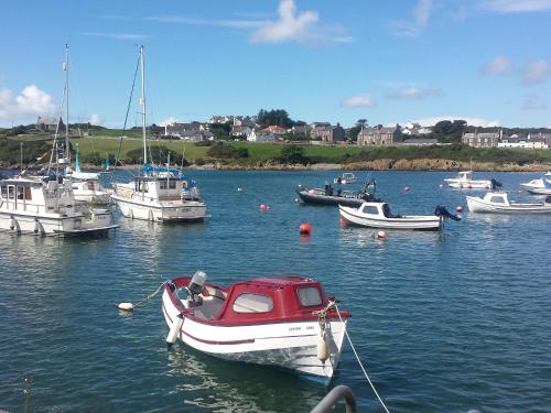 a group of boats in a body of water at Farmhouse in Dunragit