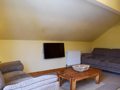a living room with two couches and a flat screen tv at Mange-Tout Maison - Uk32607 in Manton