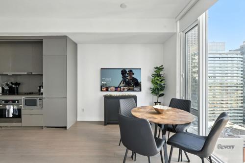 a kitchen and dining room with a table and chairs at Stylish 1BR Condo in the heart of the Downtown TO in Toronto