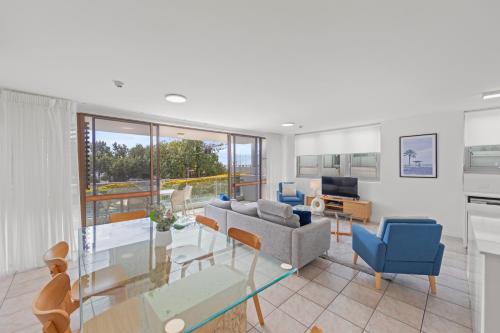 a living room with a couch and a table at Northwind Beachfront Apartments in Mooloolaba