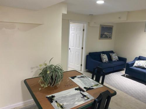 a living room with a table and a blue couch at Guest Favorite in Upper Marlboro