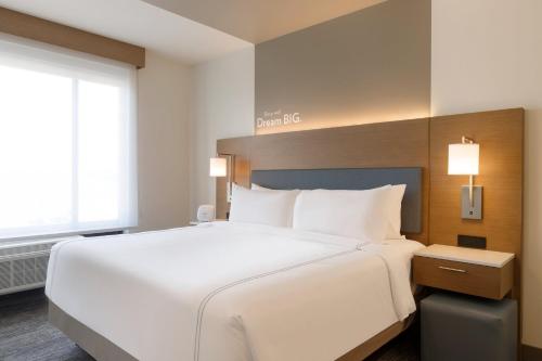 a large white bed in a hotel room at EVEN Hotels Rochester - Mayo Clinic Area by IHG in Rochester