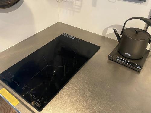 a laptop computer sitting on a counter with a pot at SNUG CAMP HOUSE - Vacation STAY 98114v in Okubo