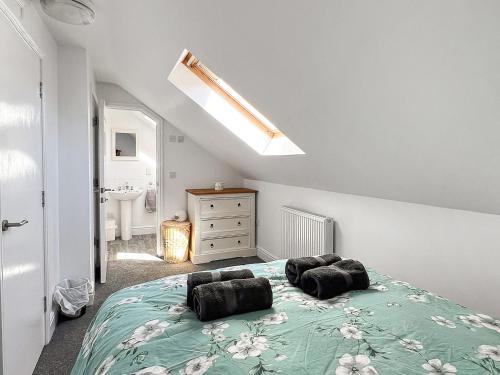 a bedroom with a bed with two pillows on it at Moglett Cottage in Fincham