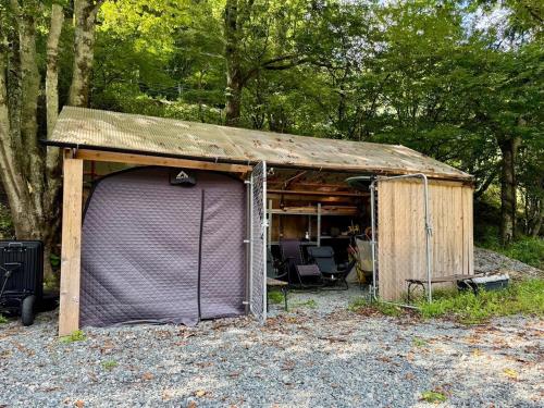 a small shed with a purple door in the woods at SNUG CAMP HOUSE - Vacation STAY 98114v in Okubo