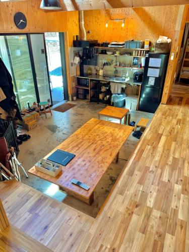 a wooden table in a room with a kitchen at SNUG CAMP HOUSE - Vacation STAY 98114v in Okubo