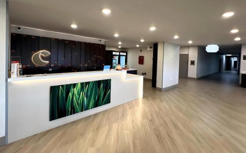 an office lobby with a reception counter with plants at Comfort Inn in Princeton