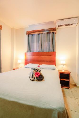 a bedroom with a large bed with a hat on it at Hotel Palmazul - Viña del Mar in Omoa