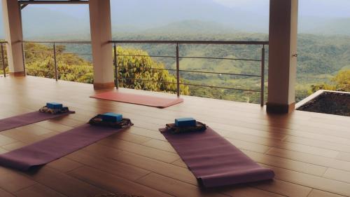 a room with three yoga mats on the floor at Vibra Healing Lodge y Spa in Teniente Hugo Ortiz