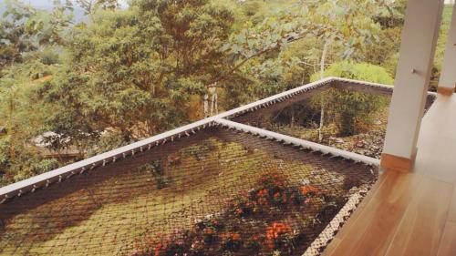 a balcony with a view of a garden with flowers at Vibra Healing Lodge y Spa in Teniente Hugo Ortiz