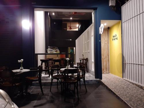 a dining room with tables and chairs in a restaurant at Bed's Friend in Bangkok