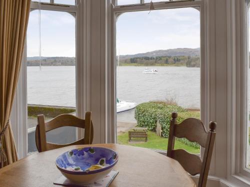 a bowl on a table in front of a window at Mere View in Ambleside