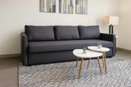a living room with a couch and two tables at Stunning Nulu 1BR CozySuites 04 in Louisville
