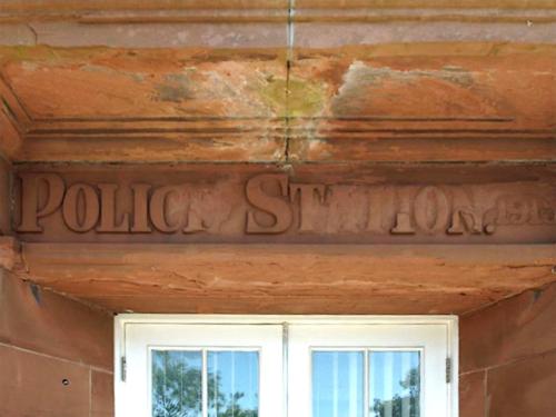 a sign on the side of a building with a window at The Police Station - Uk45642 in Silloth