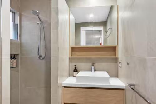 a bathroom with a sink and a shower at Seaviews Little Cove Beach Noosa 2BR 200m to beach in Noosa Heads