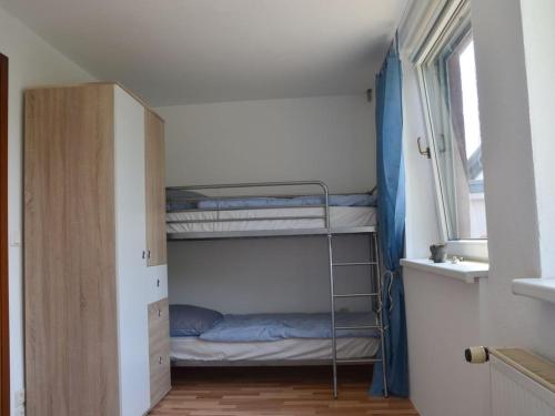 a bunk bed in a room with a window at Seaside resort Altefähr in Altefähr