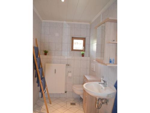 a bathroom with a toilet and a sink at Seaside resort Altefähr in Altefähr