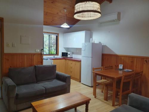 a living room with a couch and a table at Wanderers Retreat in Nelson Bay