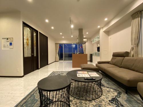 a living room with a couch and a table at Empire Skyridge Hotel - Vacation STAY 17783 in Chikugo