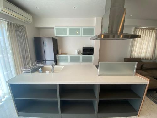 a kitchen with a counter with a sink and a refrigerator at Empire Skyridge Hotel - Vacation STAY 17783 in Chikugo