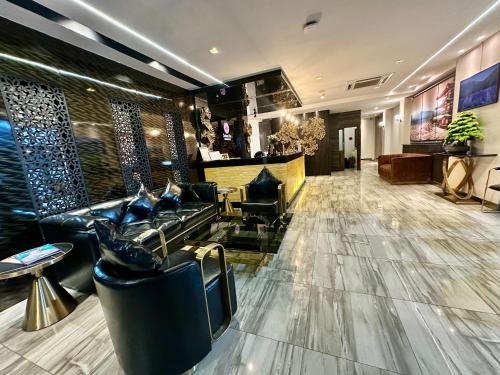 a lobby of a hotel with couches and a bar at Sakura Sky Residence in Bangkok