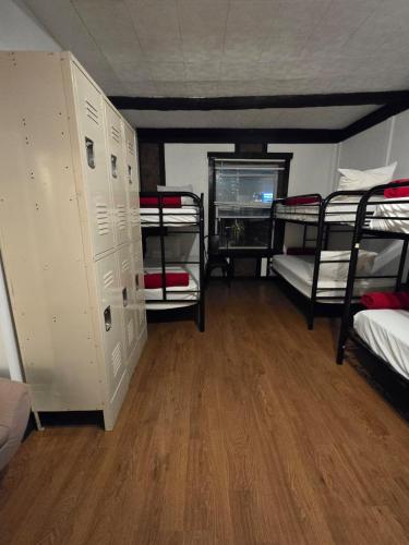 a room with four bunk beds and a wooden floor at Grand House in Chicago