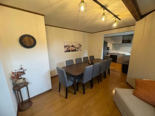 a dining room with a table and chairs at Locanda Madarao Tangram with Complimentary 8 Seater Van in Shinano