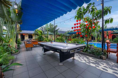 a pool table in the middle of a patio at Tam Coc Forest Bungalow & Spa in Ninh Binh