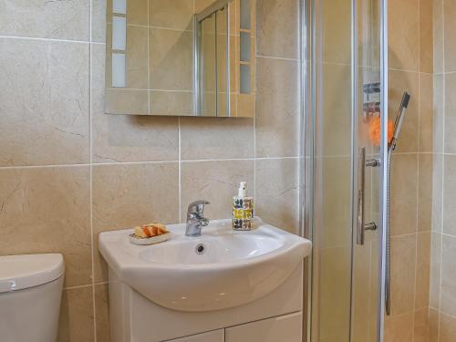 a bathroom with a sink and a shower at Ferndale in New Milton