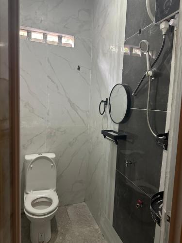 a bathroom with a white toilet and a mirror at Pelik homestay kempas jb in Johor Bahru