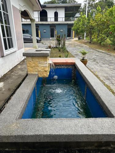 a water fountain in the middle of a house at Pelik homestay kempas jb in Johor Bahru
