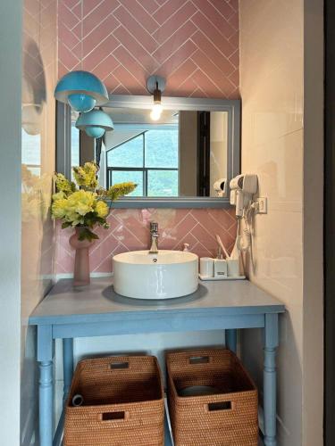 a bathroom counter with a sink and a mirror at Le Soleil villa ba vì in Ba Vì