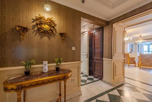 a hallway with a table with plants on it at Nabeel Homes - Four Seasons City View Residence in Alexandria