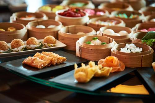 a bunch of different types of food on plates at Grand Mercure Danang in Da Nang