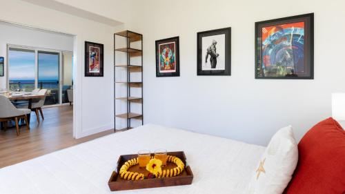 a room with a bed with a tray of food on it at ❤PiH❤ Sun Ray RetreatOcean Sunsets ViewsOptional Mauna Kea Hotel Privileges in Waimea