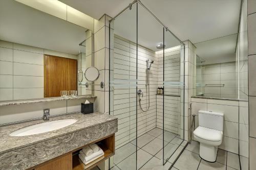 a bathroom with a toilet sink and a shower at Concorde Hotel Kuala Lumpur in Kuala Lumpur