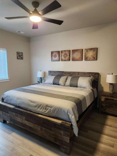 a bedroom with a large bed with a ceiling fan at StarLuxe Stay and Play in Star