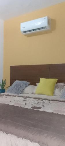 a bedroom with a bed with a light on the wall at Tesoro Palmas Resort in Mazatlán