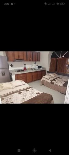 two photographs of a bedroom with two beds and a counter at Tesoro Palmas Resort in Mazatlán