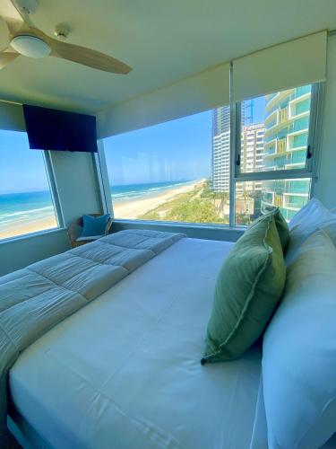 a bedroom with a bed with a view of the beach at One The Esplanade Apartments on Surfers Paradise in Gold Coast