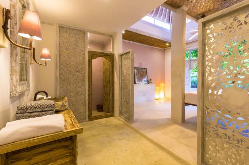 a bedroom with a door leading into a room at BoHo Bingin Beach Bali in Uluwatu