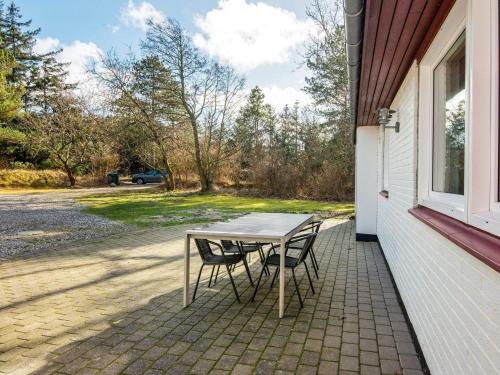 a table and two chairs sitting on a patio at 18 person holiday home in Rømø in Kongsmark