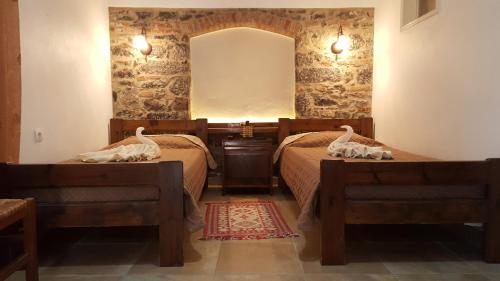 a bedroom with two beds and a mirror at Agroktima in Mármaron