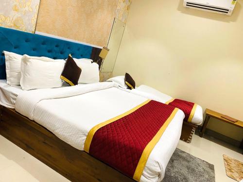 a bedroom with a bed with a colorful blanket at Hotel Tulsi Grand inn in Vrindāvan